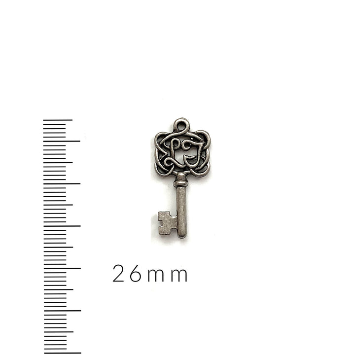 alt="antique pewter key charm"