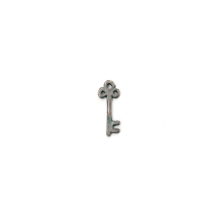 alt="artisan verdigris skeleton key charm"